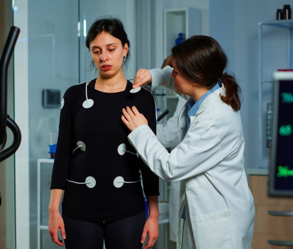 Scientist researcher preparing woman patient for endurance test attaching electrodes on professional body equipment. Team of doctors monitoring health of patinet, vo2, ekg scan runs on computer screen. SSUCv3H4sIAAAAAAAACpRVy66kNhDdR8o/XLGOFb8f+YfZTJZRFsY23WgAt4CeZHR1/z3Fw2AYbktRS62m6rhcdU5x+v3XX97eitIOtSv+eHufnuC5bprnMPZ2rGMHYfzbGu9D50OfR773TOI8EHw9xr62TR4s7ejunW0DBLtn00zhjzlZDKMdn0MYstvb2vVxGKP79oA2IEFSnRbCj3sc4yFa1rcFPWUgwVLC98G2w1jP91KVwi428dmX8d+8CKGsryAgtkj4EUKbQ5ztDvfsFYf7cxxDP2cPCR8ecaj3nveMbWz74xB5xM6LI8bHMvxctI2TLqEJbejGqSrL+HR2DDcQ4MBo0vev5fktJdaxRkgVfz5iPw6/fw0OWJuFX+9bJnyWE+hLPbjQNLYLEZRJ+eXqz+q6OnQu/I9qy4+/NxZucH6i6v0jm7OH+e2yN+tUhfDcUl4qxDzTiHPFkJHBIO2E0rqUgRua2ihExUtJuEdOVAJxUWpkNXwF6zGTzhgn+Ab2pJKOE4GEIBRxT0tkOVTGXvGKkLKSHm9girWVxEpECJXQhlRIY8URLpknTgtijdzA0nOhiNGIOssQxxQjbZRHlilCfUkt8dXMzEJH8e0f2LN21nYlwj59HTOtv0dnm/NWPPra1d0tOxbH+/wmp2MuPruxn2gutuaaGB+2bKa3p4KaIcXvdhgA7lM8Xz/wjdhm93RxnEVaqxYe9nN6JIxKQTTXShDGCRerNKsh3GuoM7eTGnw+mmh9mC7dtuzCKiTRRlPQYNu3k2vMACEY3wFnA1kwissMc/CSFaCw3AEHV7nIJ4O5ym1Ws+Q0FVndk+ssGM1pdv7kPwvEKEGz/k9OdIVJnnSVS+50eS73qRlgOCXJhq8cawEZyfGCSQ4yOUNbwyxHmS8FMowb/Am/hilGXol3AmSTGyw1Z+rz6QBgiOCX1Ew5ZtRL2ieMZPo1O4ZgwSh+uQaGSAagF2tAMYVNo4nkw98uYGp/+JM4kVxwohTDRJjNEBLHQKi9xcHB4MAsJZhjgg3Z/TLnu6BESsmoEls+0V1UGHOGnUTSYrBsQz3Yn6FIeWesoXo/kYtQcAqzS6l2O08aFETARULz/bKzBAWXUmDO8e7vPylQQHnYEbk3cOa/MERBF4rN7ryyWk9rWwghKPZeoUC9n4ayyNLgUTCcV0z6Ej5w6uM/AAAA//8DAHS44mJ8CQAA